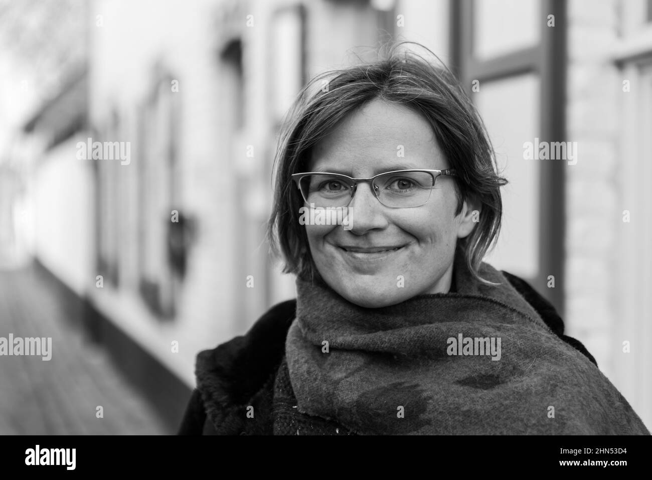 Young beautiful 30 year old woman standing in a street, Lissewege, Belgium Stock Photo