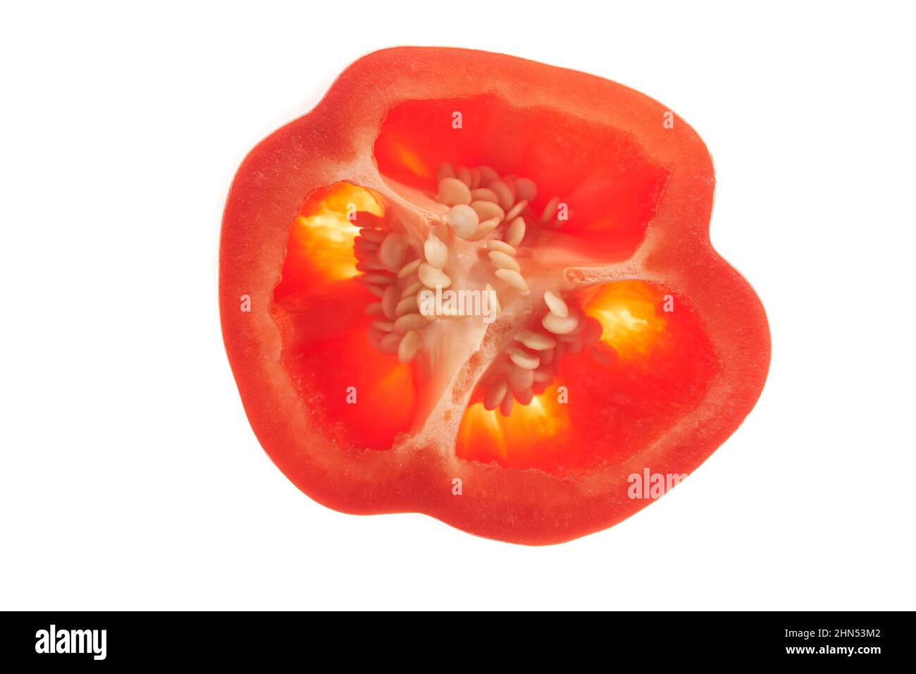 Isolated on a white background. Top view. Close-up of a piece of sweet red bell pepper with seeds inside. Detail of half a red pepper. High quality photo Stock Photo