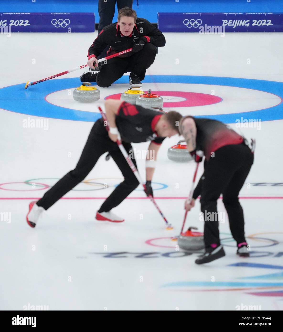 Beijing, China. 14th Feb, 2022. Mikkel Krause (top) of Denmark competes during the Curling Men's Round Robin Session 8 of the Beijing 2022 Winter Olympics between Denmark and Norway at the National Aquatics Centre in Beijing, capital of China, Feb. 14, 2022. Credit: Zhou Mi/Xinhua/Alamy Live News Stock Photo