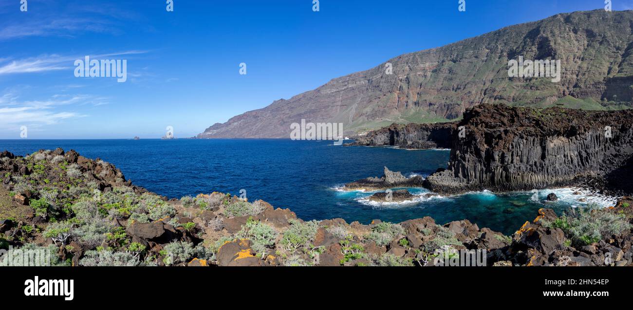 El Hierro - overgrown volcanic rocky coast in the El Golfo valley Stock Photo
