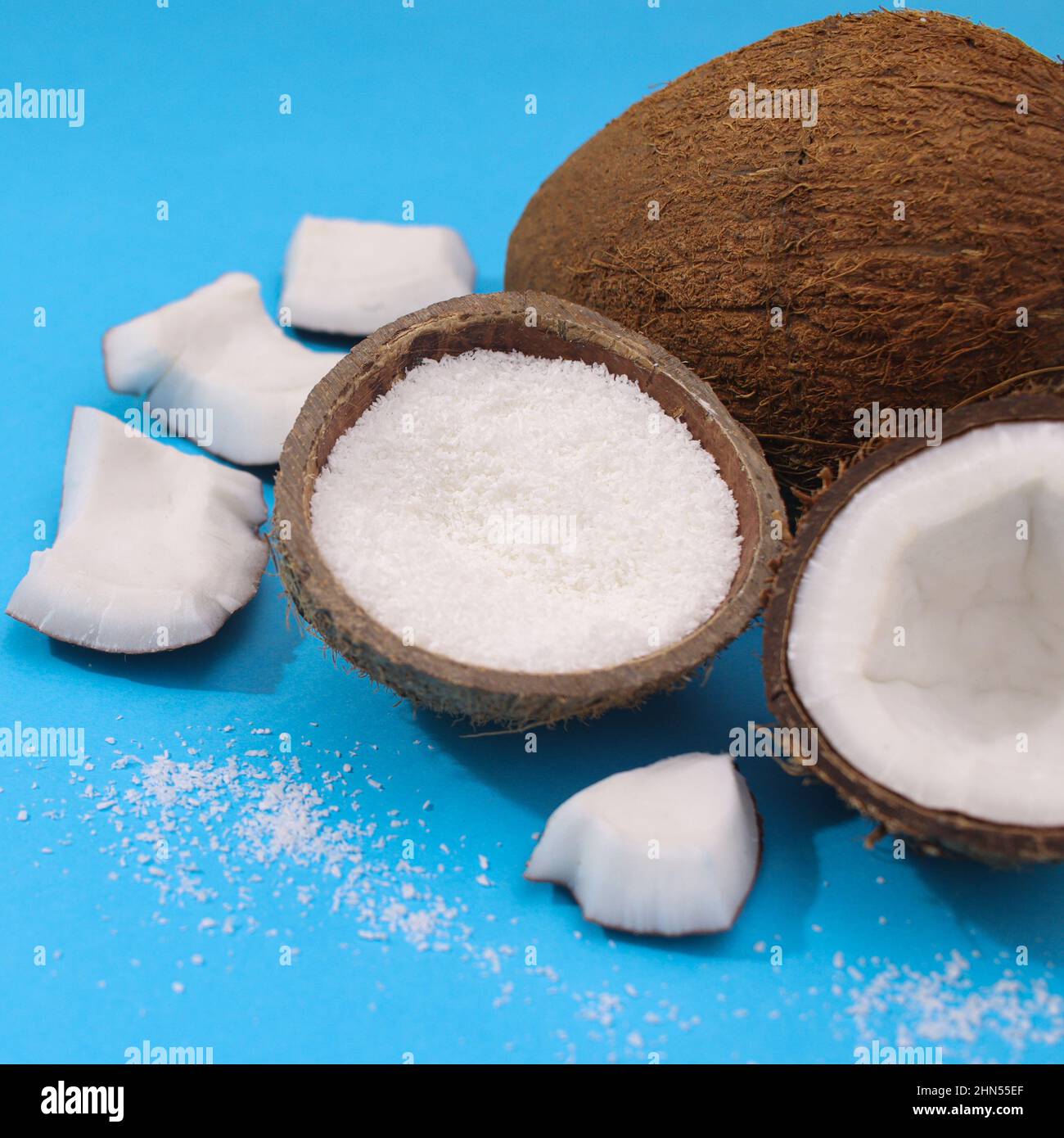Summer tropical coconut on vibrant blue background. Minimal exotic fruits Stock Photo