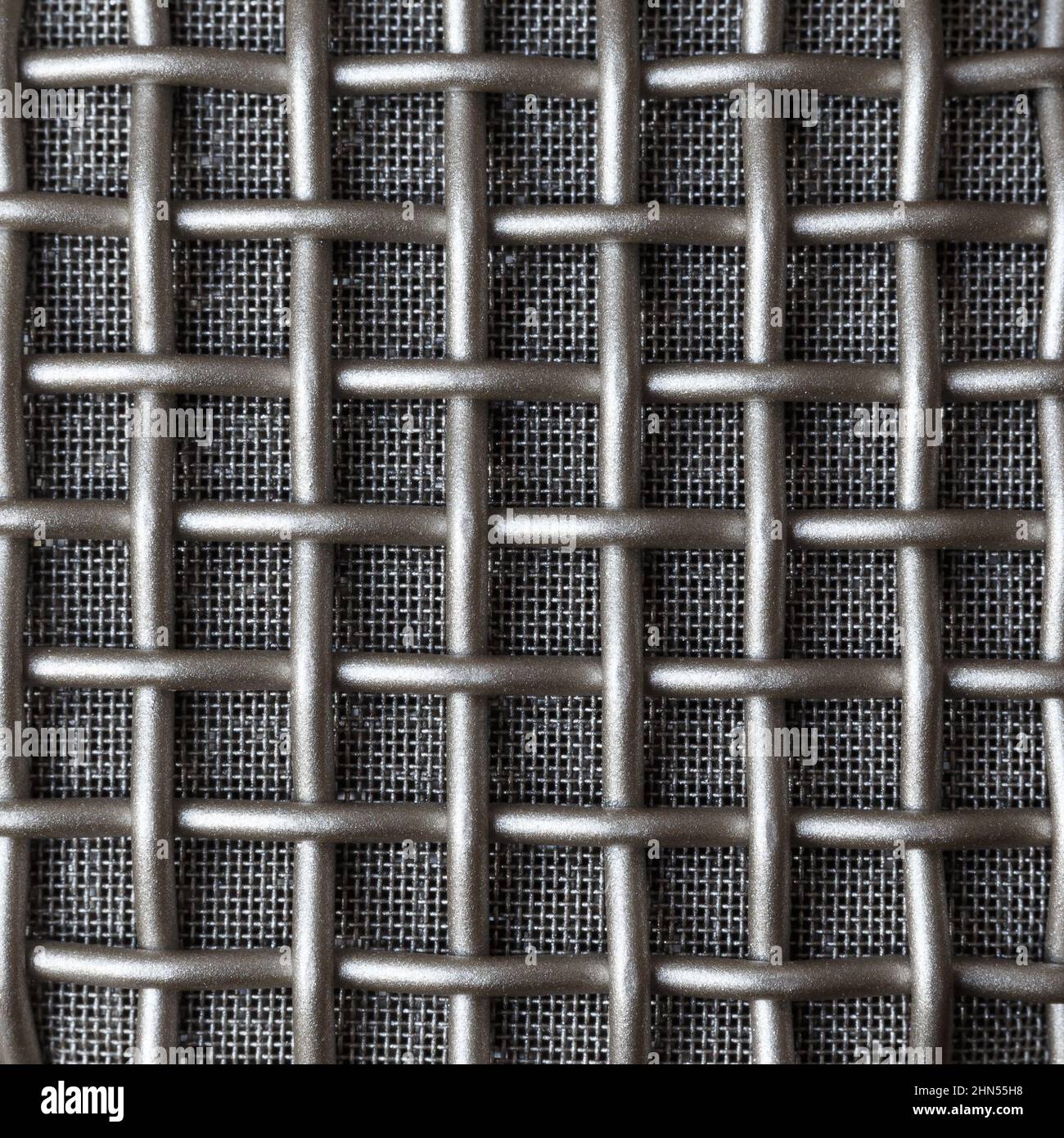 Double metal grille of different density on the microphone ear pad. Macro. Stock Photo