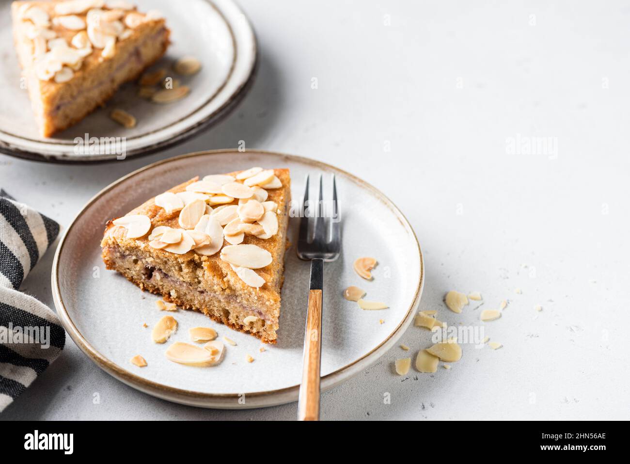 Slice of almond cake on a dessert plate, closeup view. Vegan almond cake Stock Photo