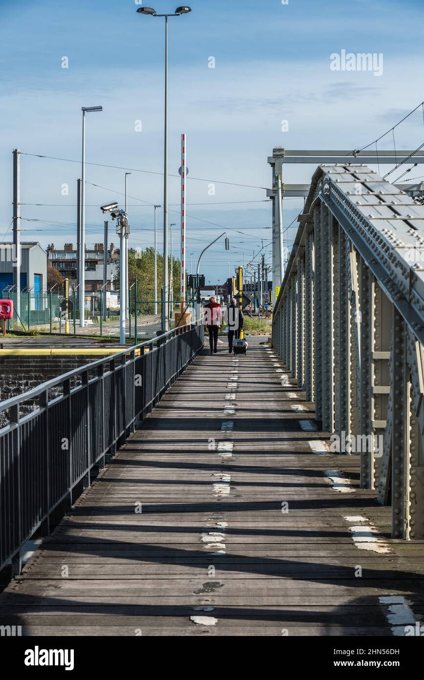 Zeebrugge, Flanders - Belgium - 10 30 2018: Couple walking over the sea bridge Stock Photo