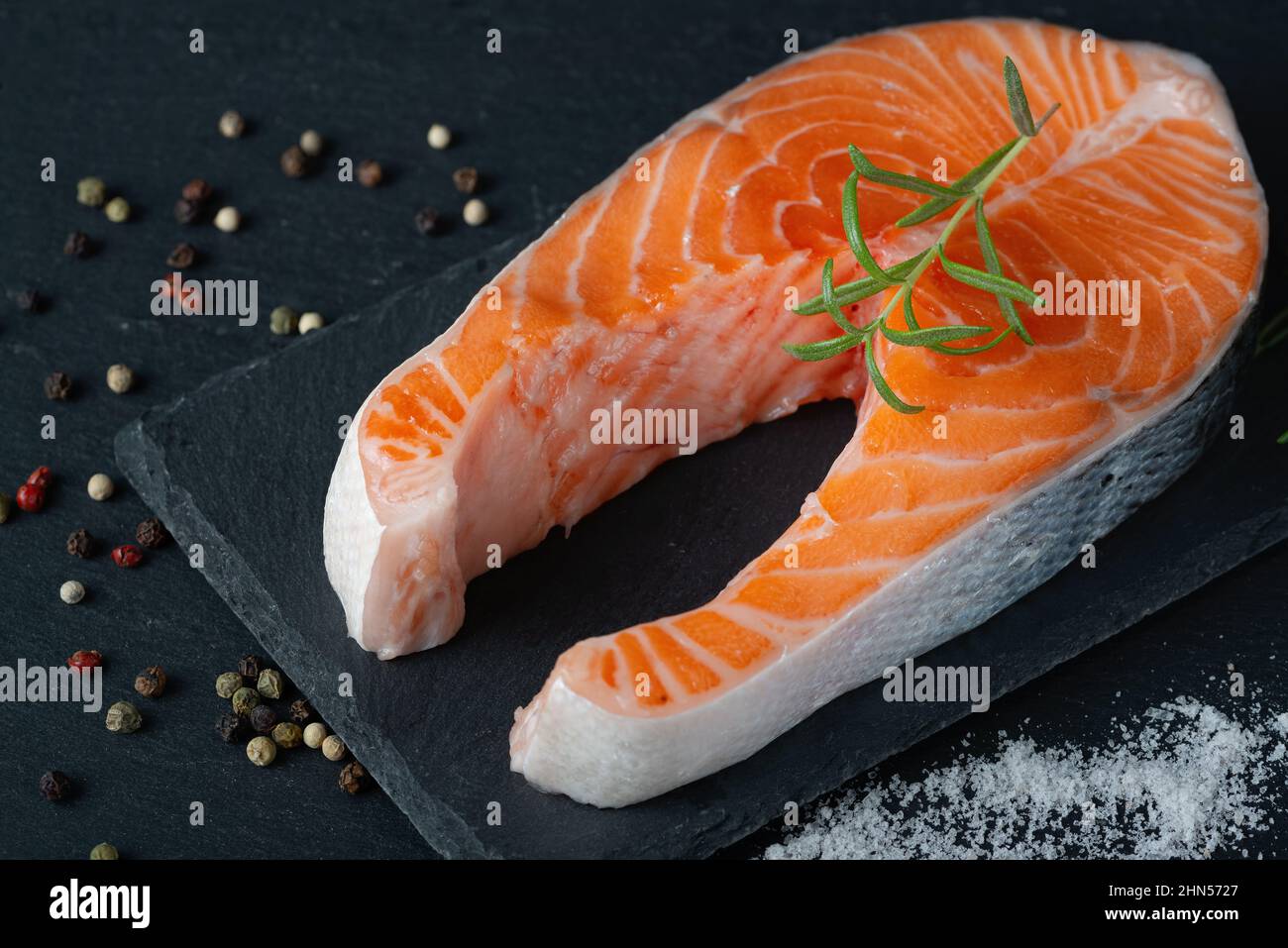 Raw salmon fillet and ingredients for cooking, seasonings and herbs