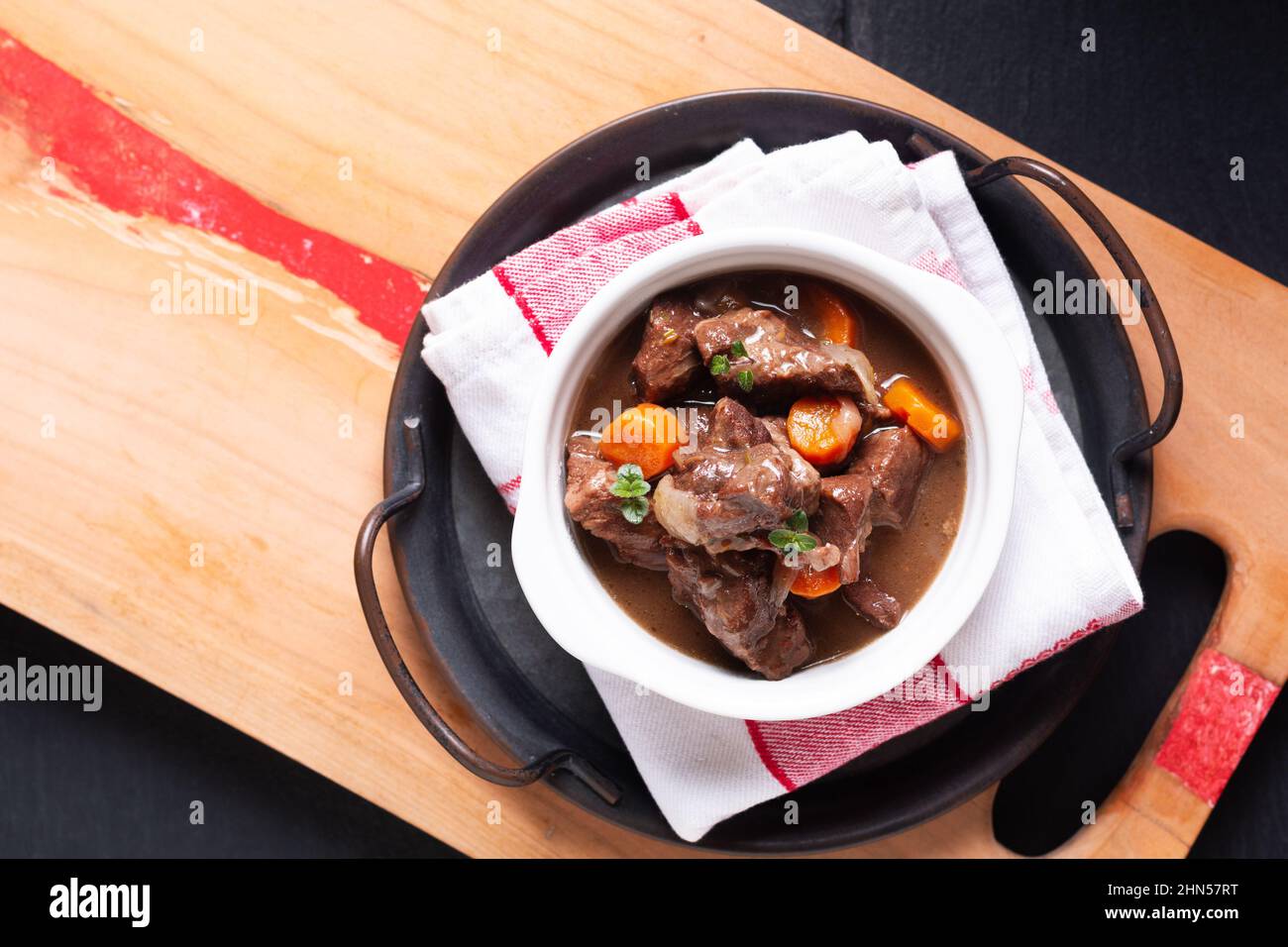 Food concept French red wine beef stew bourguignon on wooden board with copy space Stock Photo