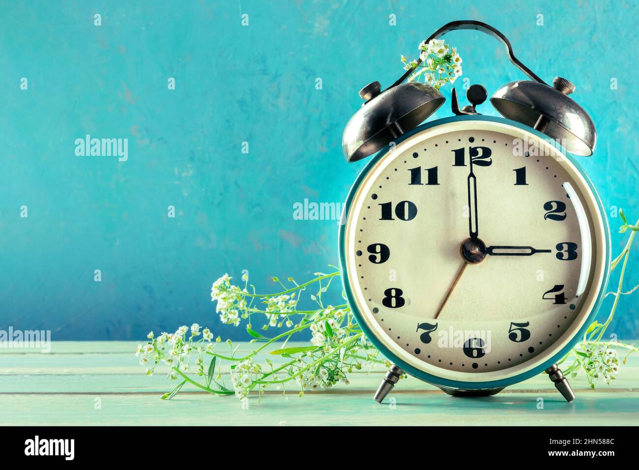 Daylight Savings Time concept, spring forward. A retro alarm clock with