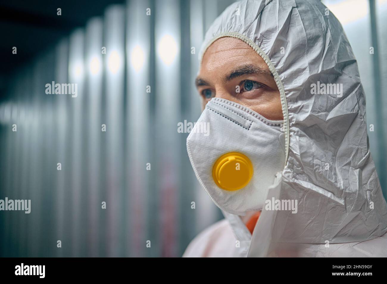 Man in the protective gear staring into the distance Stock Photo