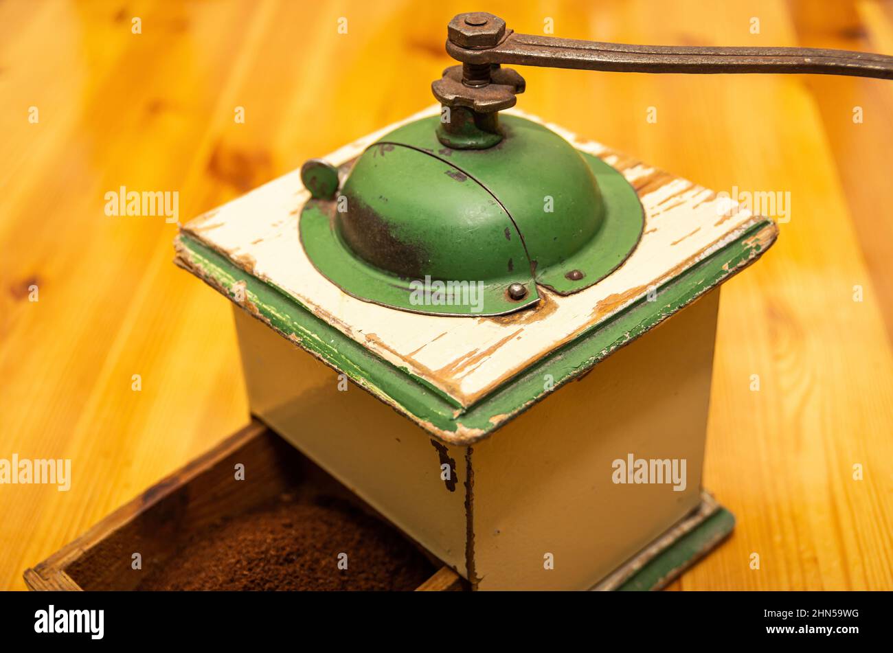 An old crankdriven manual burr mill for grinding coffee or similar