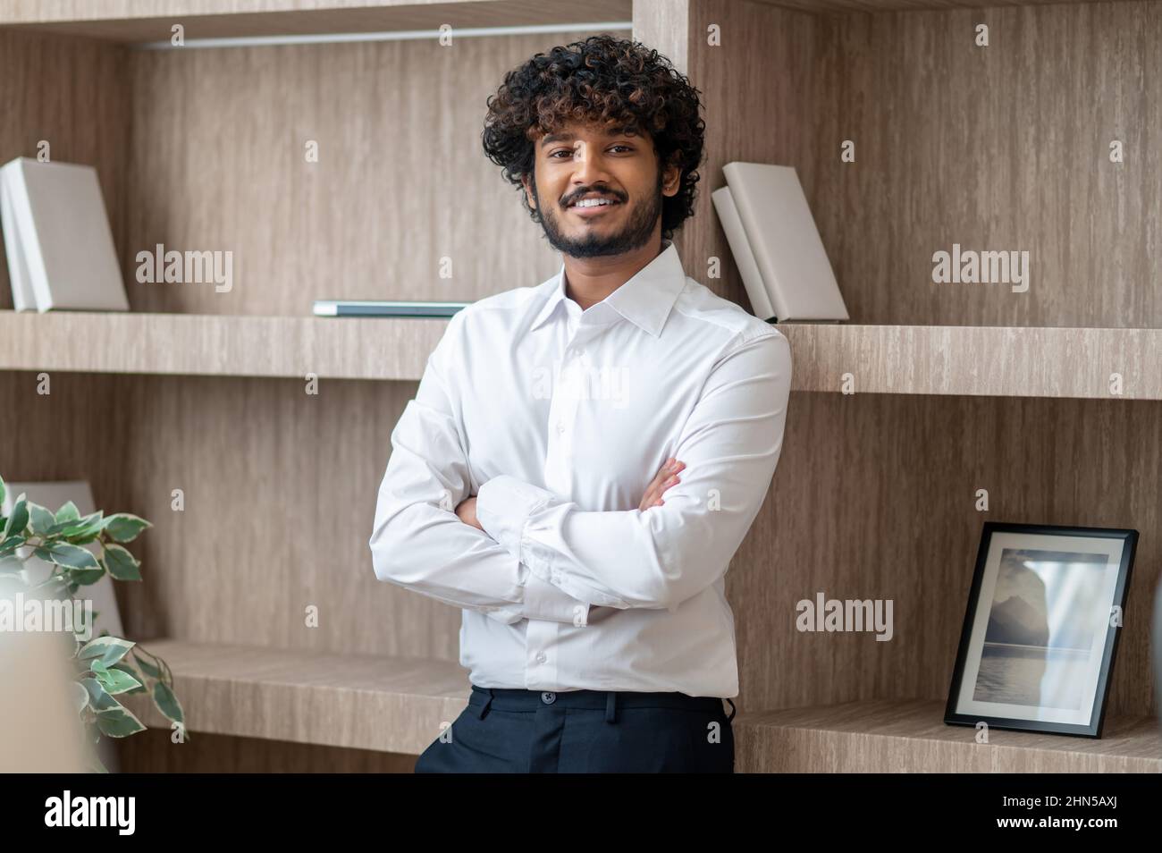 Young indian businessman sstanding with arms crossed Stock Photo - Alamy
