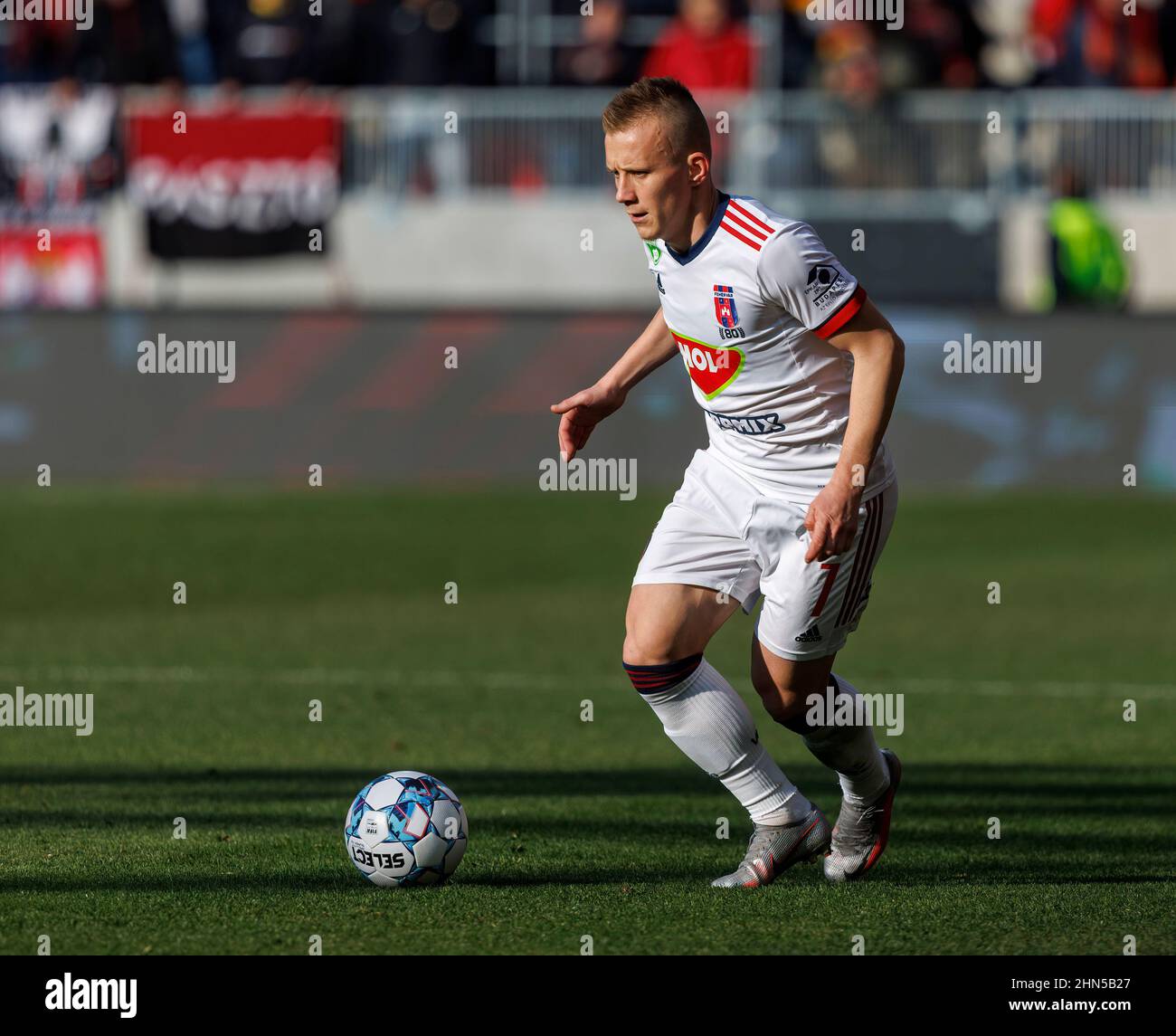 Ivan Petryak of MOL Fehervar FC dribbles between Franck Boli of