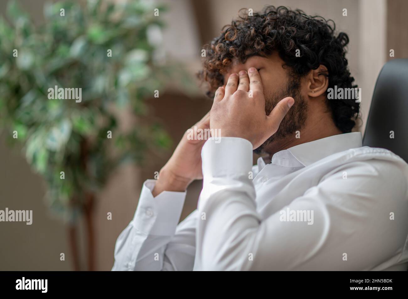 Dark-haired businessman feeling sleepy Stock Photo