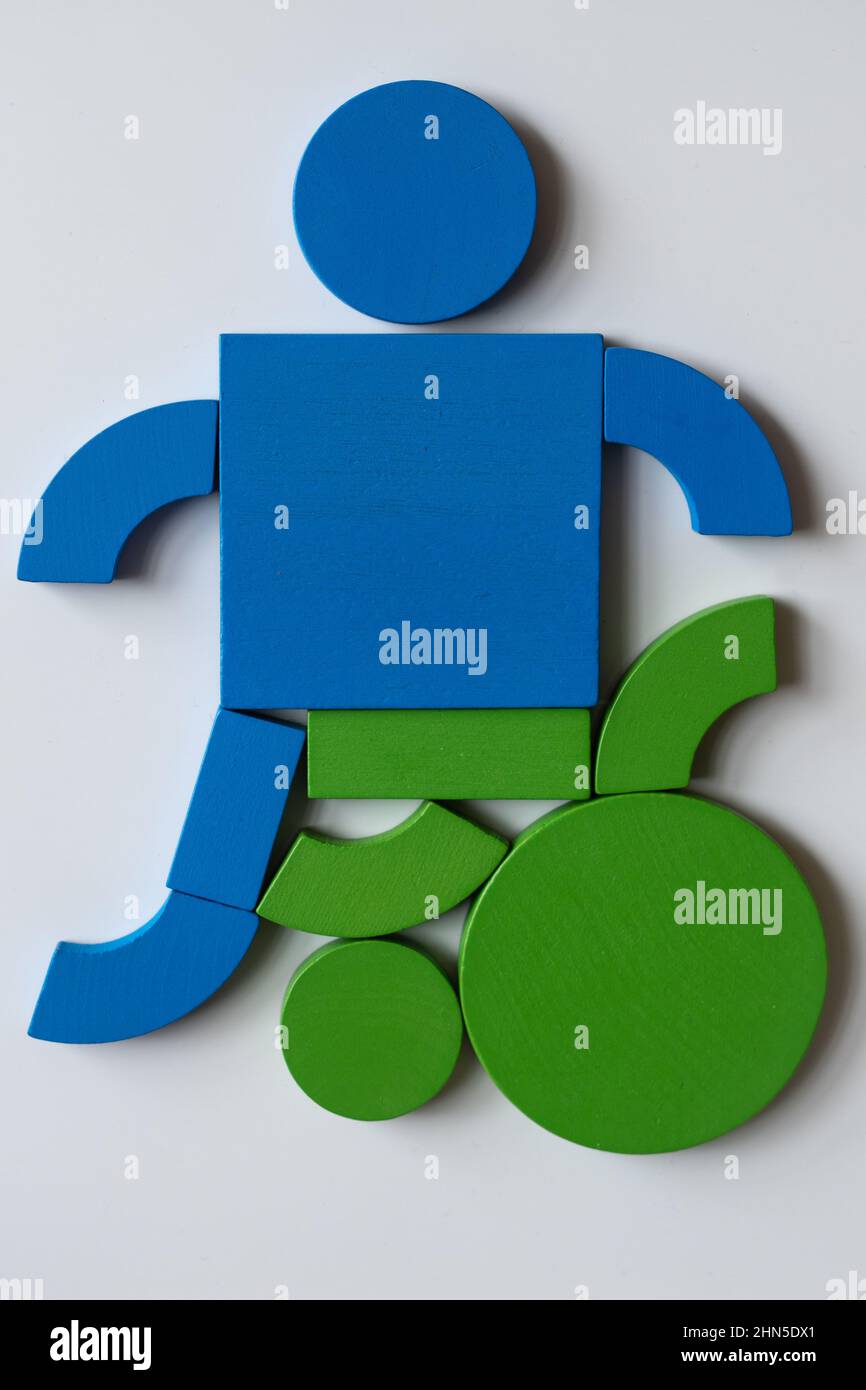 Person sitting in a wheelchair, made out of brightly colored wooden