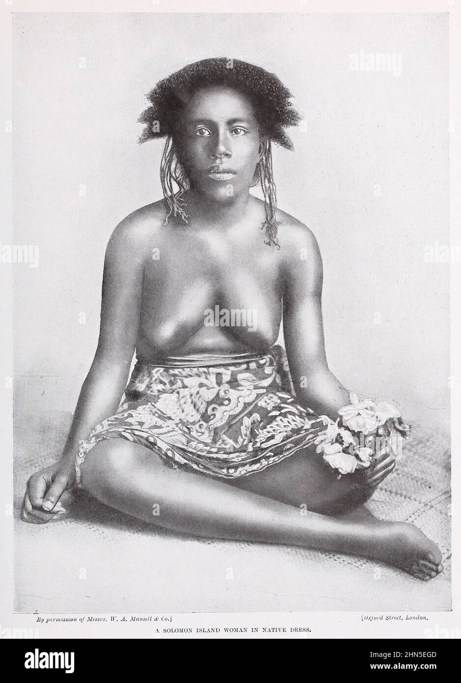 A Solomon Islands woman (Fijian type) in native dress from The living races of mankind : a popular illustrated account of the customs, habits, pursuits, feasts & ceremonies of the races of mankind throughout the world Volume 1 by Sir Harry Hamilton Johnston, Henry Neville Hutchinson, Richard Lydekker and Dr. A. H. Keane published London : Hutchinson & Co. 1902 Stock Photo
