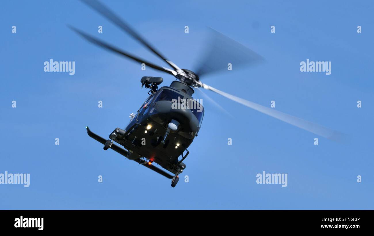 Thiene Italy, OCTOBER, 16, 2021 Modern military helicopter in flight in the foreground in the blue sky. Front close-up view. Agusta Westland AW139 HH1 Stock Photo