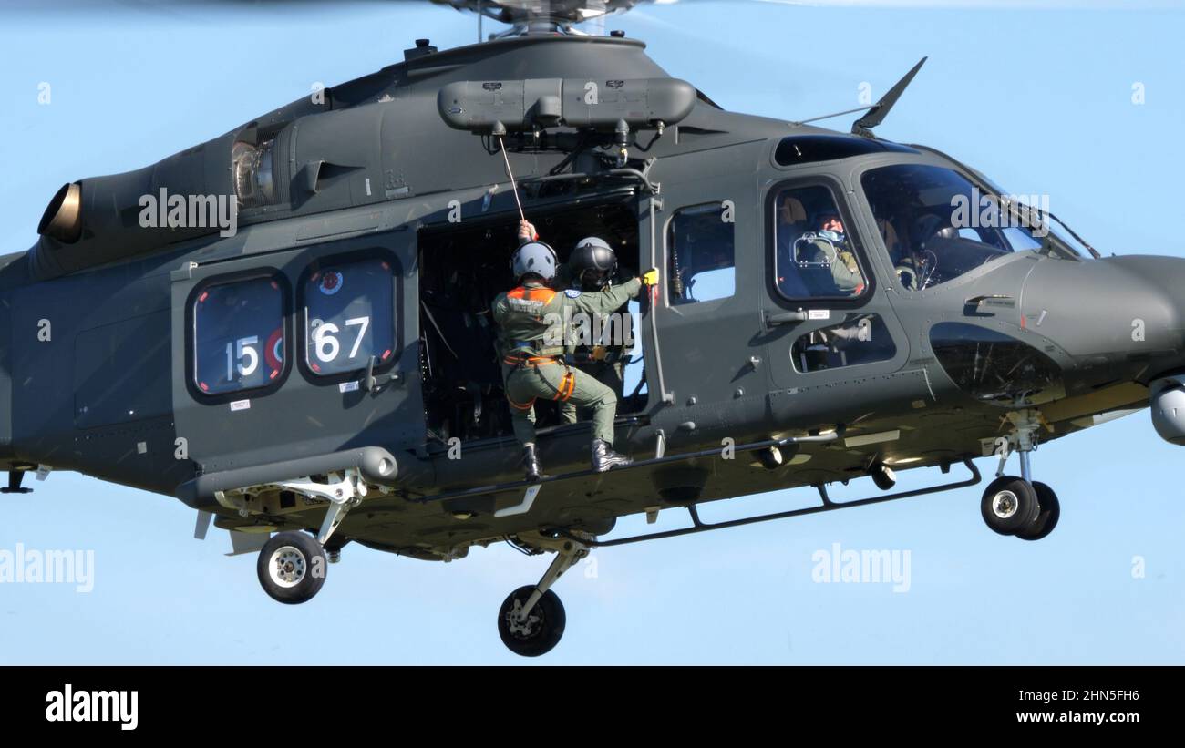 Thiene Italy, OCTOBER, 16, 2021 Rescuer descends with the winch from the side hatch of a military helicopter. Rescue in extreme conditions. Agusta Wes Stock Photo
