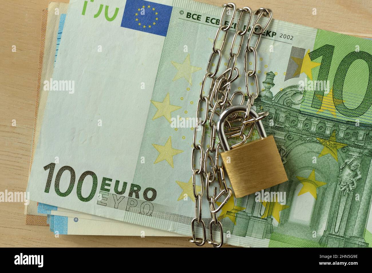 Closeup of euro banknote locked with chain and padlock - Stop cash concept Stock Photo