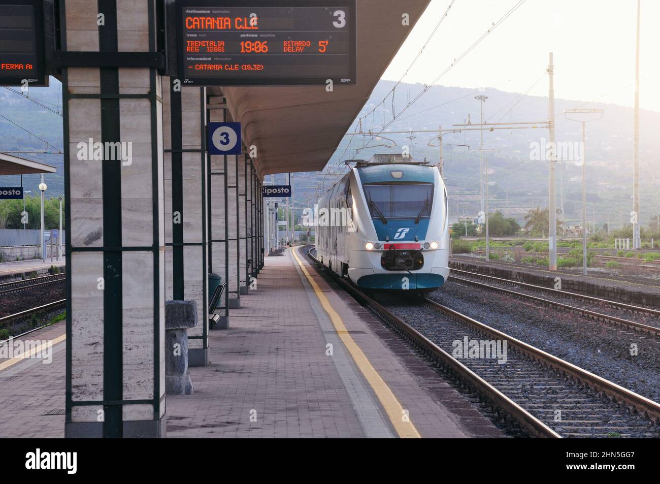 Giarre-Riposto, Italy - May 11, 2012: Passenger train arrives to the platform. Stock Photo