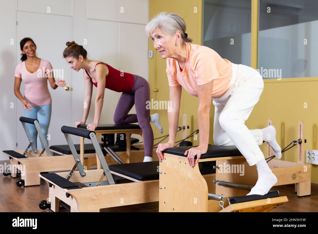Elderly woman doing exercises on wunda chair in pilates studio Stock Photo Alamy