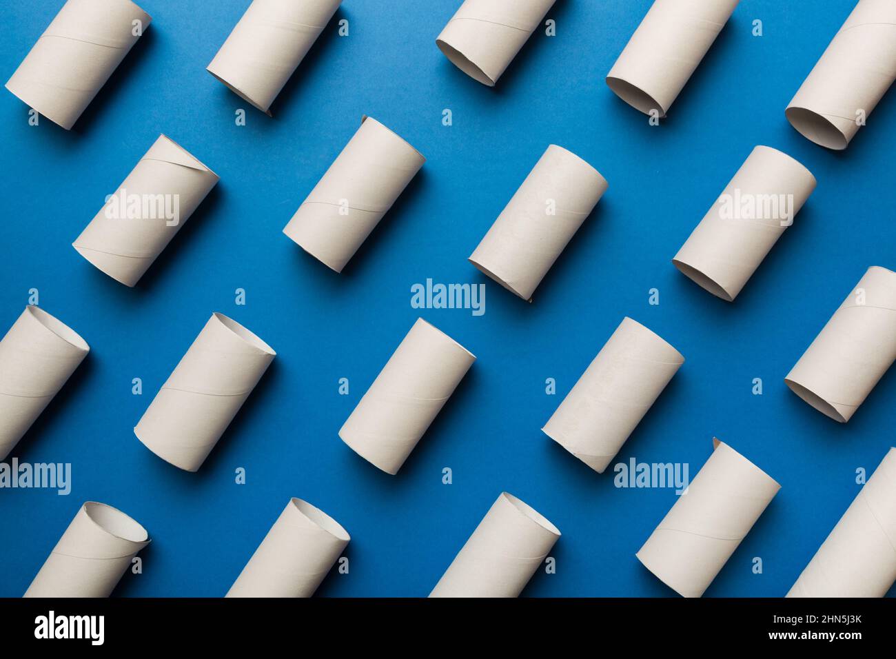 Empty toilet paper roll on colored background. Recyclable paper tube