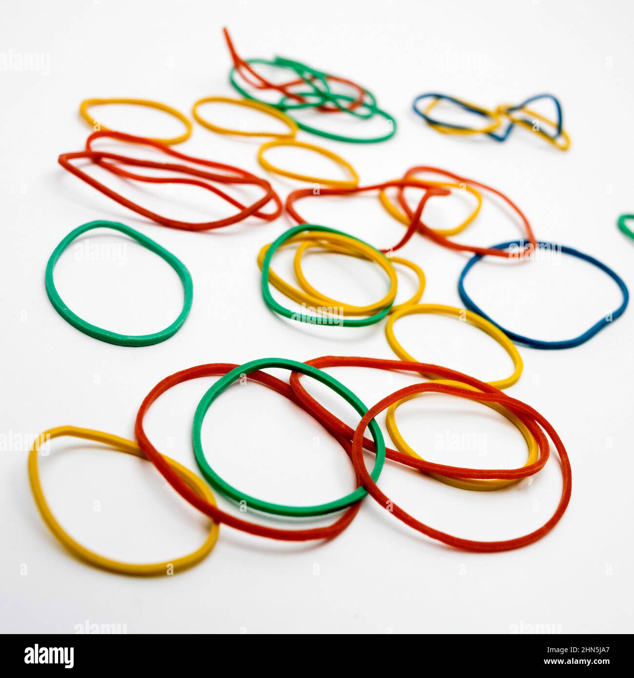 Closeup high angle shot of colorful rubber bands on a white background Stock Photo