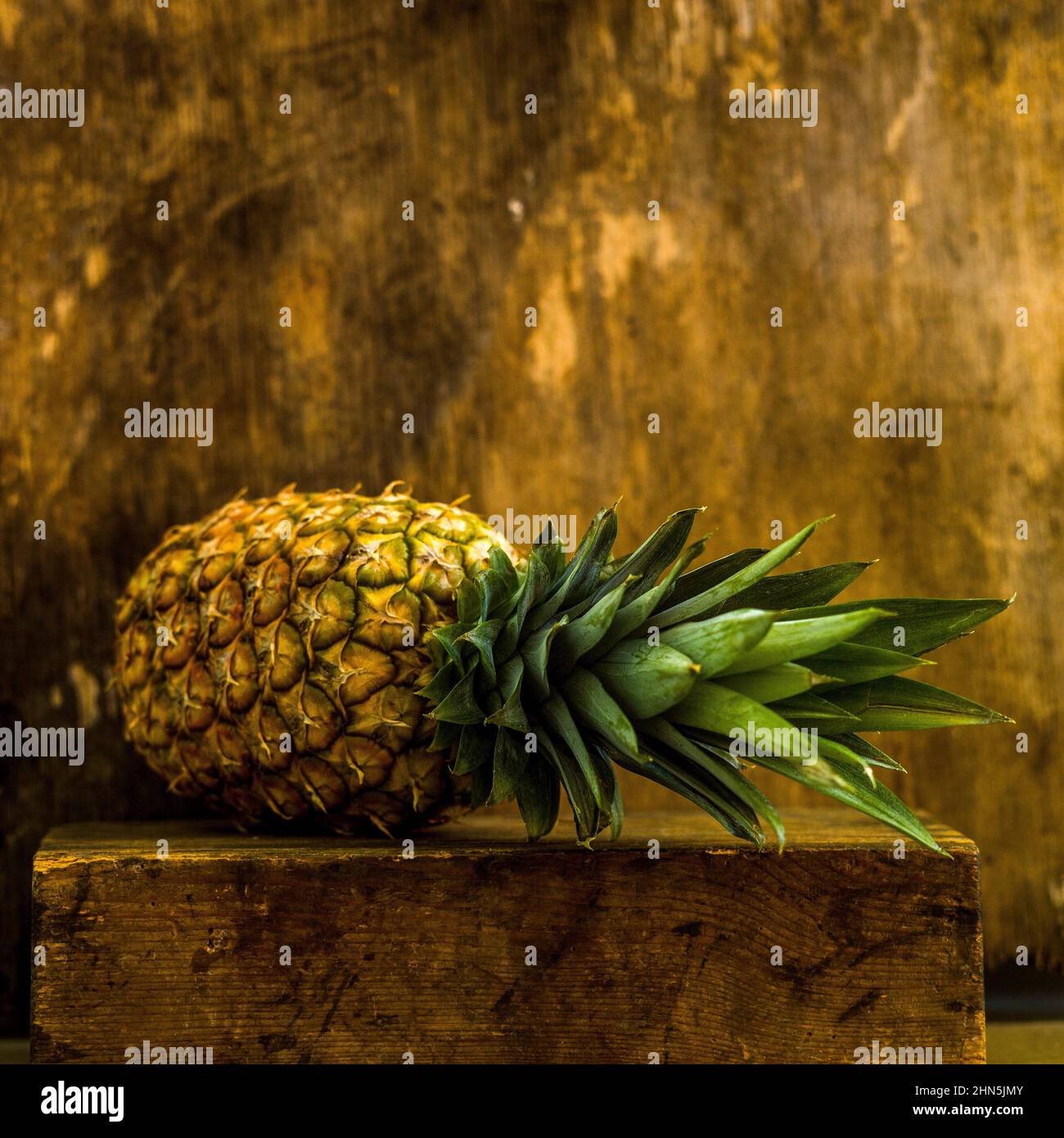 Closeup shot of fresh pineapple on a wooden surface Stock Photo