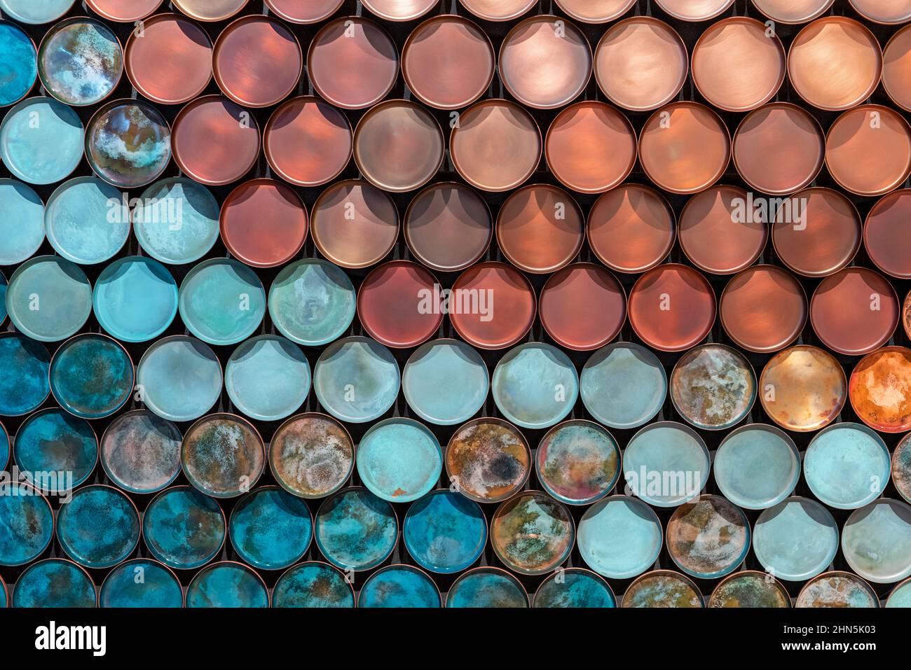 Top view of full frame textured backdrop of bright blue and red plates placed in parallel rows Stock Photo