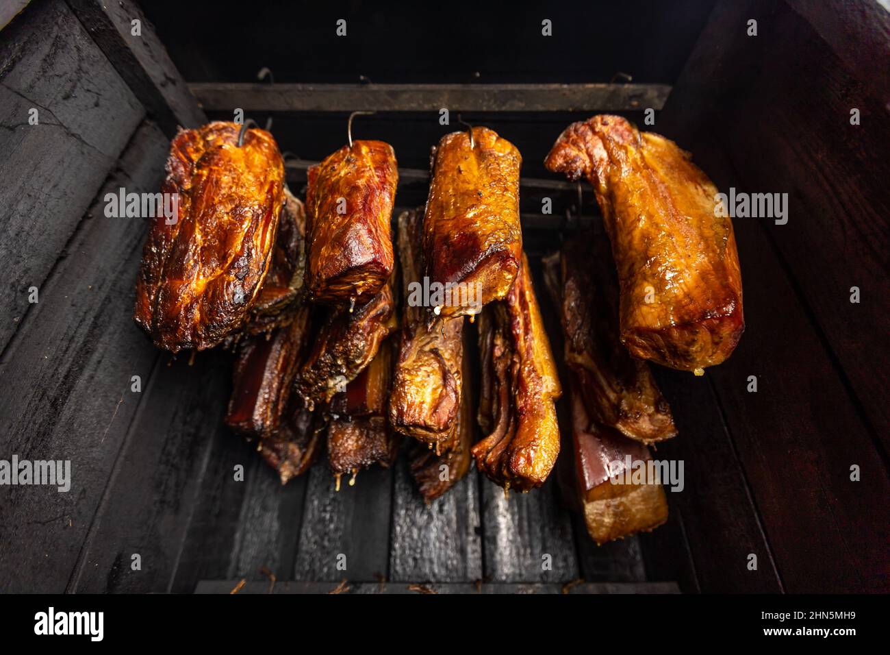 Traditionally smoked meats in a smokehouse, food concept Stock Photo