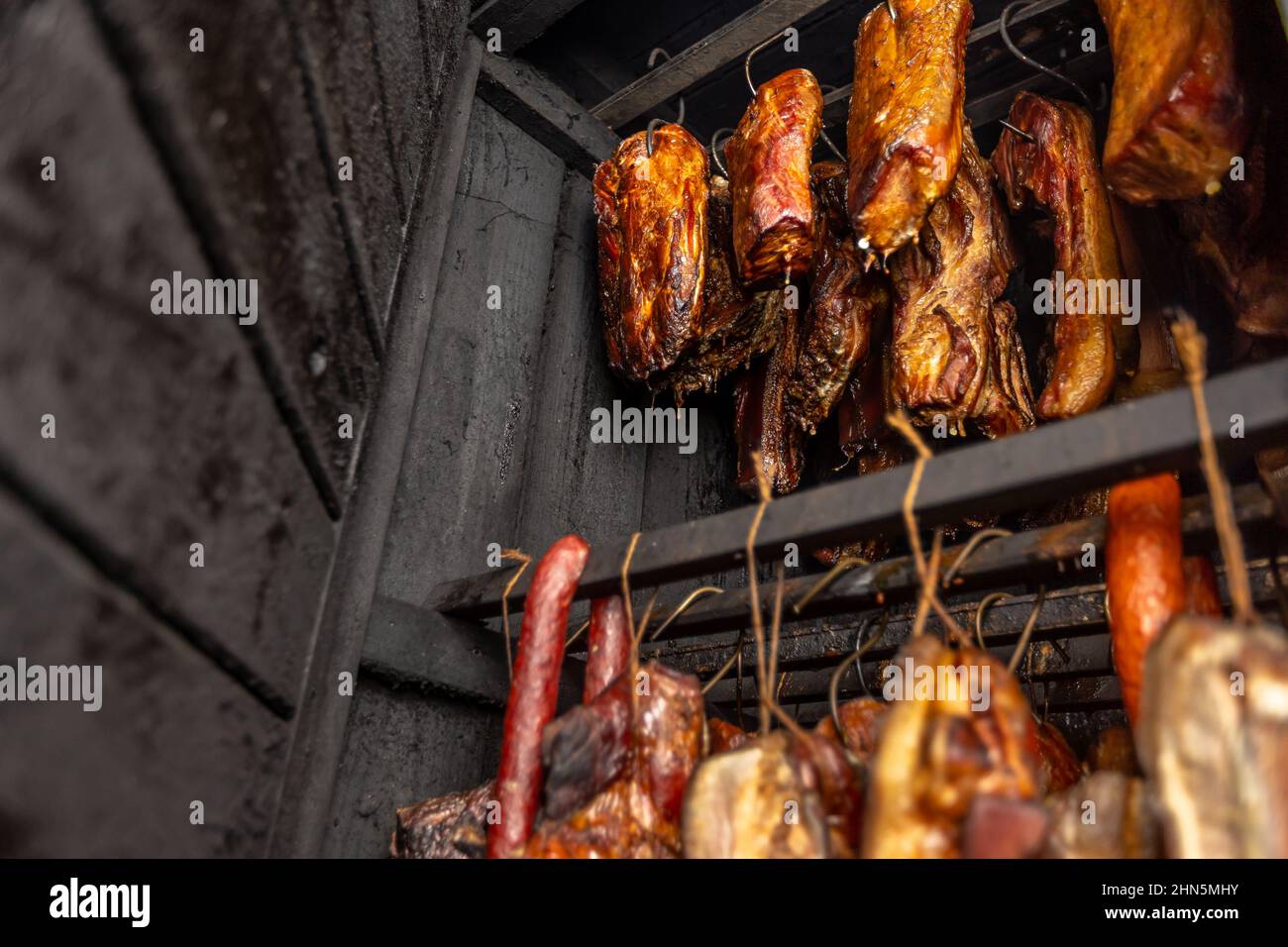Traditionally smoked meats in a smokehouse, food concept Stock Photo