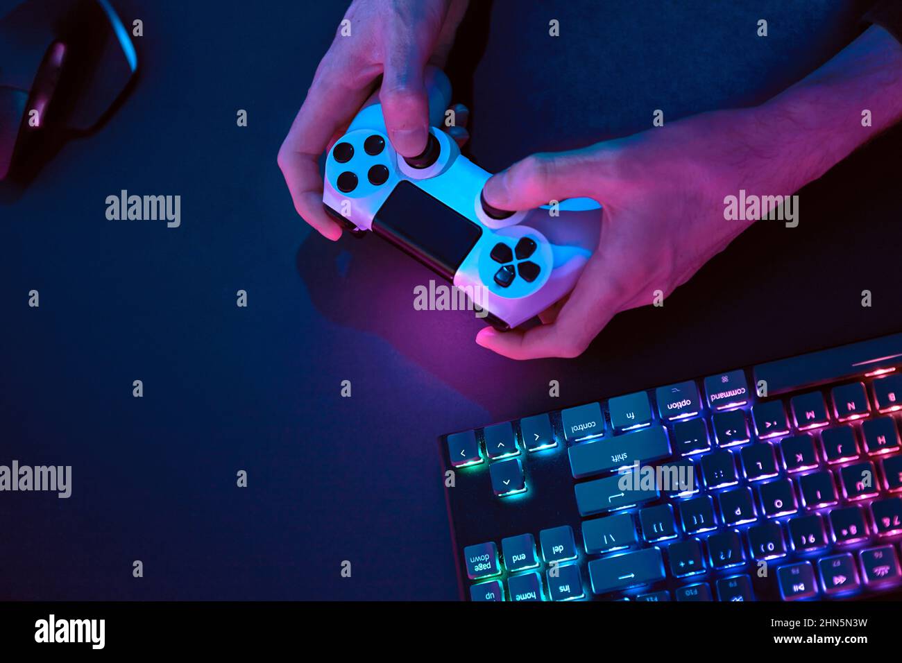 Computer Controller Inhand Male hands using controller for controlling computer. Rainbow colors ...