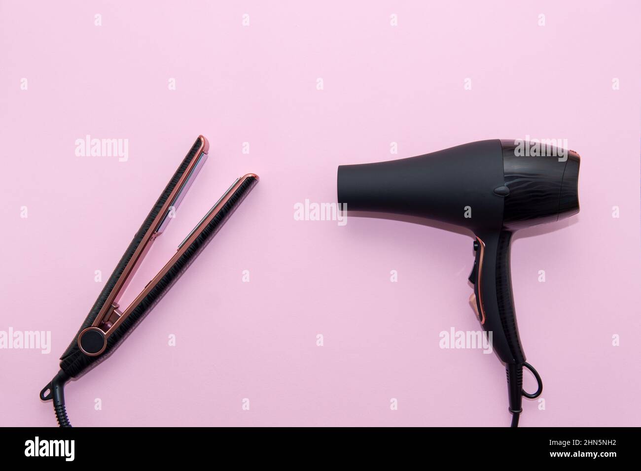 Top view of black hair straightening iron and a hairdryer on pink background. Hair care concept, copy space Stock Photo - Alamy Top view of black hair straightening iron and a hairdryer on pink background. Hair care concept, copy space Stock Photo - Alamy