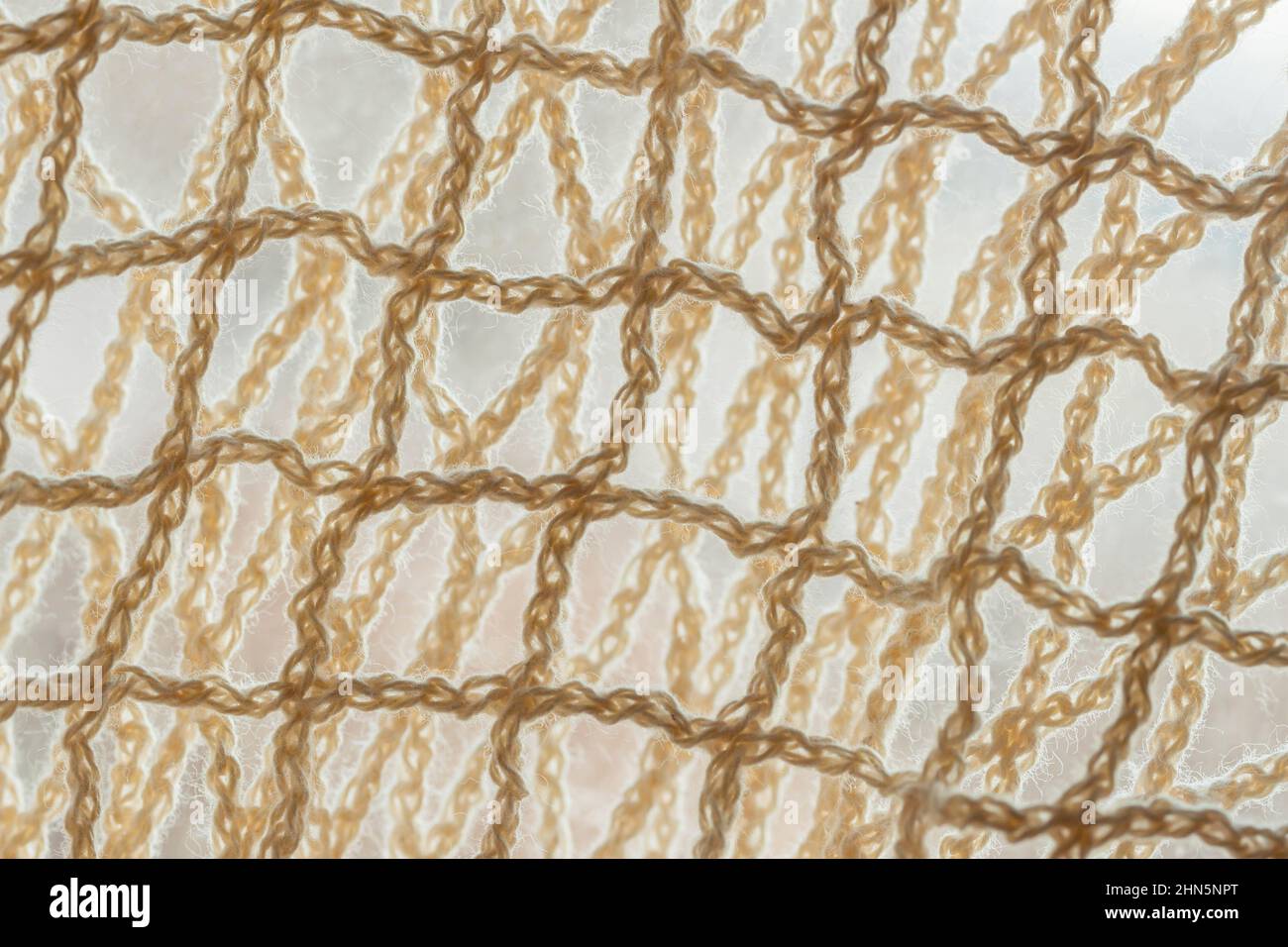 Mesh natural netting fabric close-up, light background Stock Photo