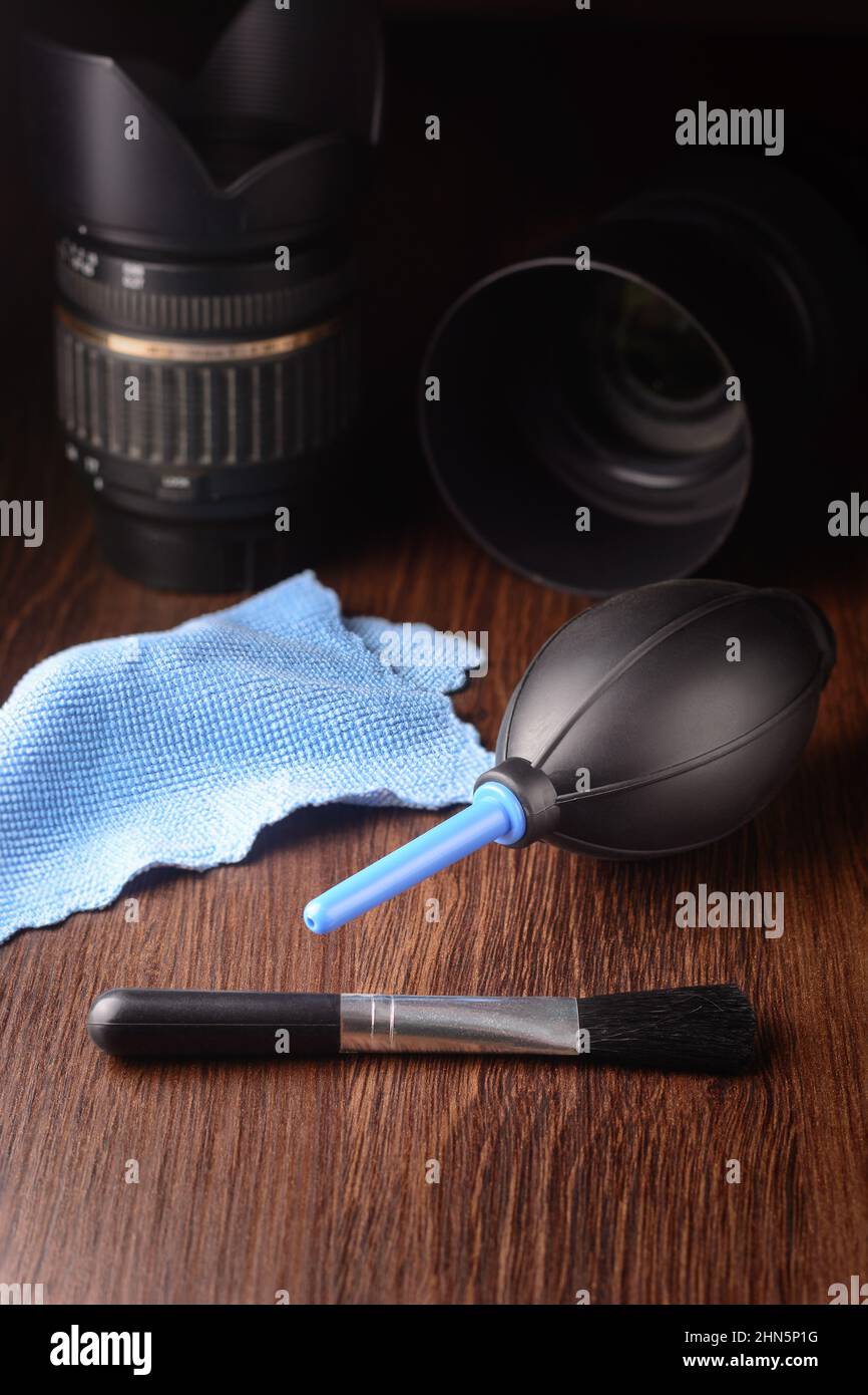 lens cleaning kit with dslr lenses, on a dark background, camera