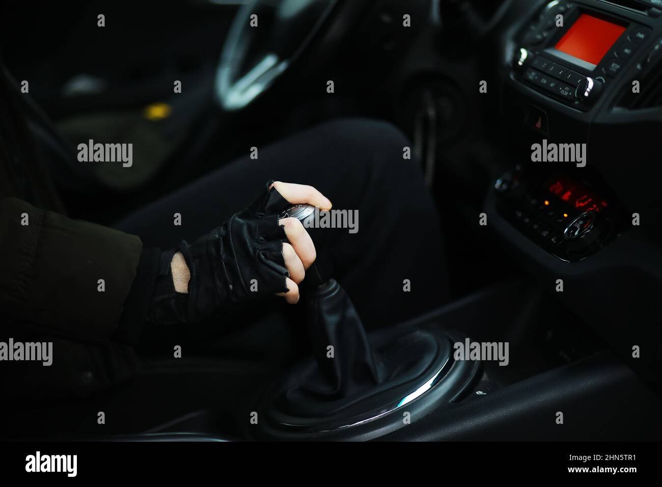 Hand on car gear knob. The driver switches the speed in the car. Hand