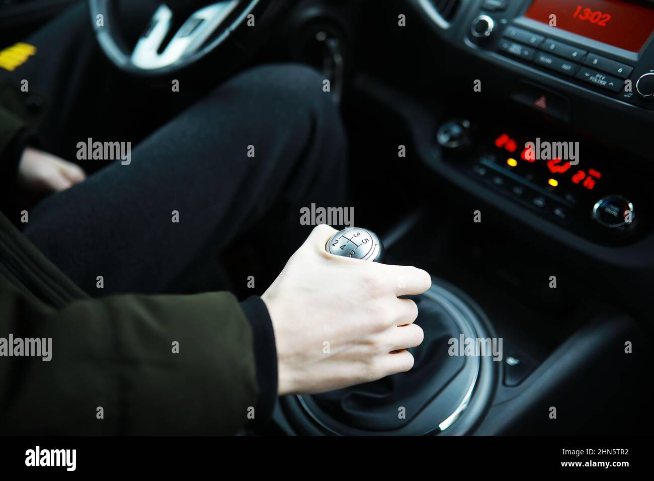 Hand on car gear knob. The driver switches the speed in the car. Hand
