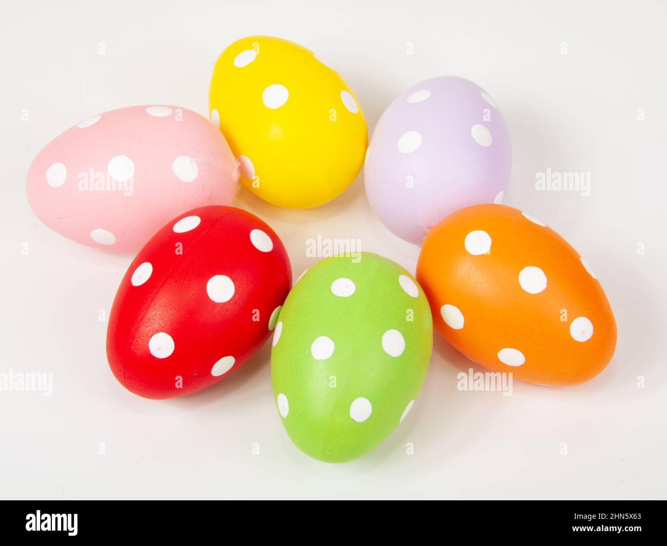 Multicolored easter eggs in dots on the white background Stock Photo