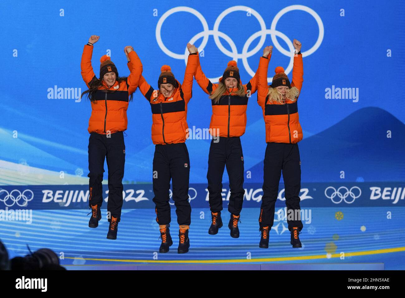 Beijing, China. 14th Feb, 2022. Members of Team Netherlands gold medalists Selma Poutsma, Suzanne Schulting, Yara van Kerkhof, and Xandra Velzeboer leap onto the podium during the medals ceremony for the Women's Short Track 3000m Relay at the Beijing 2022 Winter Olympics on Monday, February 14, 2022. Photo by Paul Hanna/UPI Credit: UPI/Alamy Live News Stock Photo
