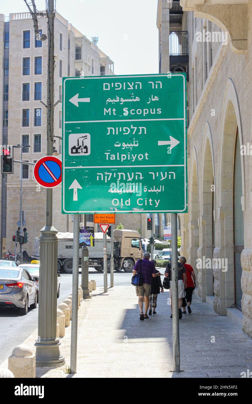 Trilingual road signs printed in Hebrew, Arabic and English direct travelers in Jerusalem, Israel. Stock Photo