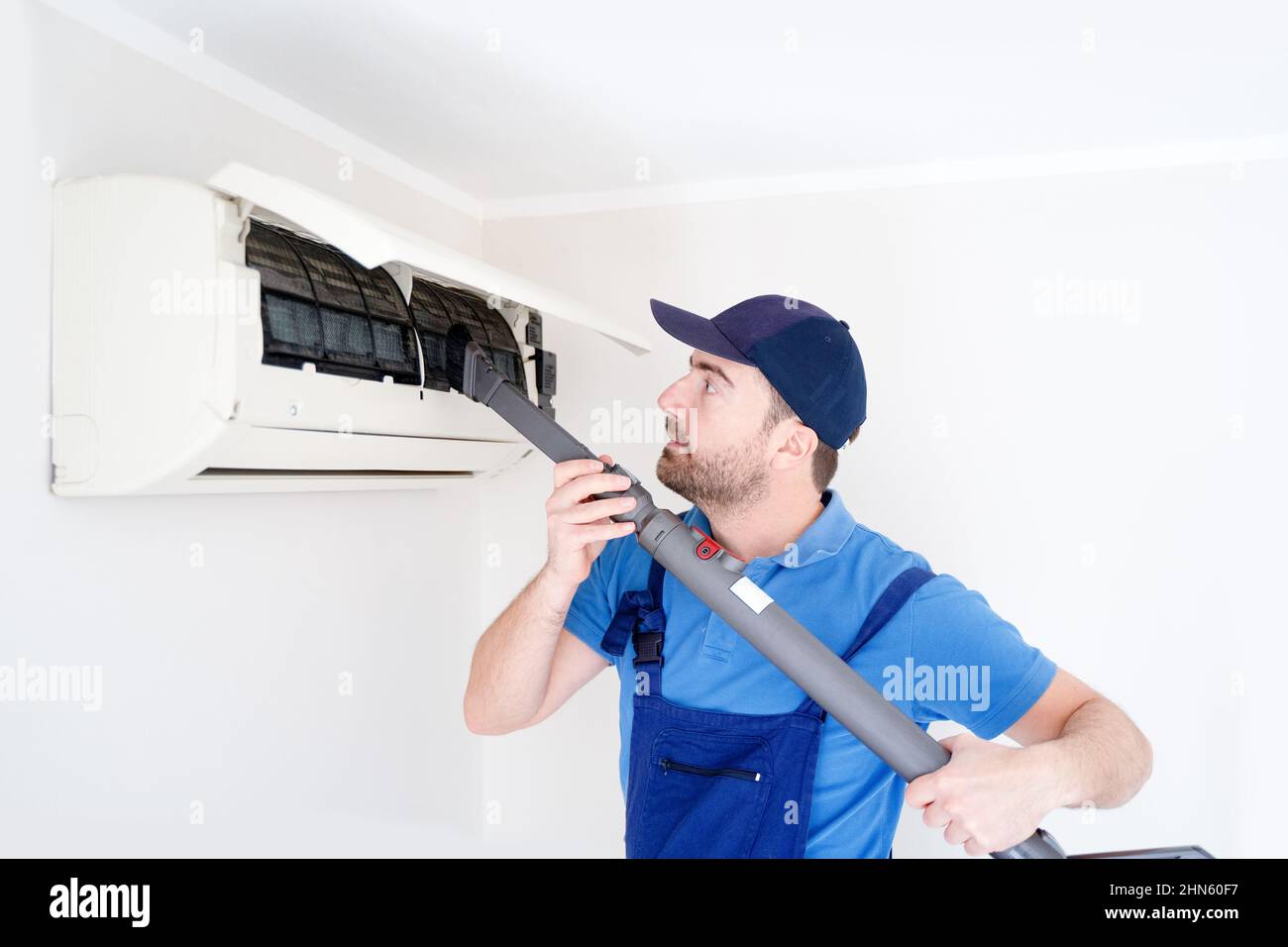 Technician cleaning air conditioner filter on the wall at home for hvac service Stock Photo Alamy