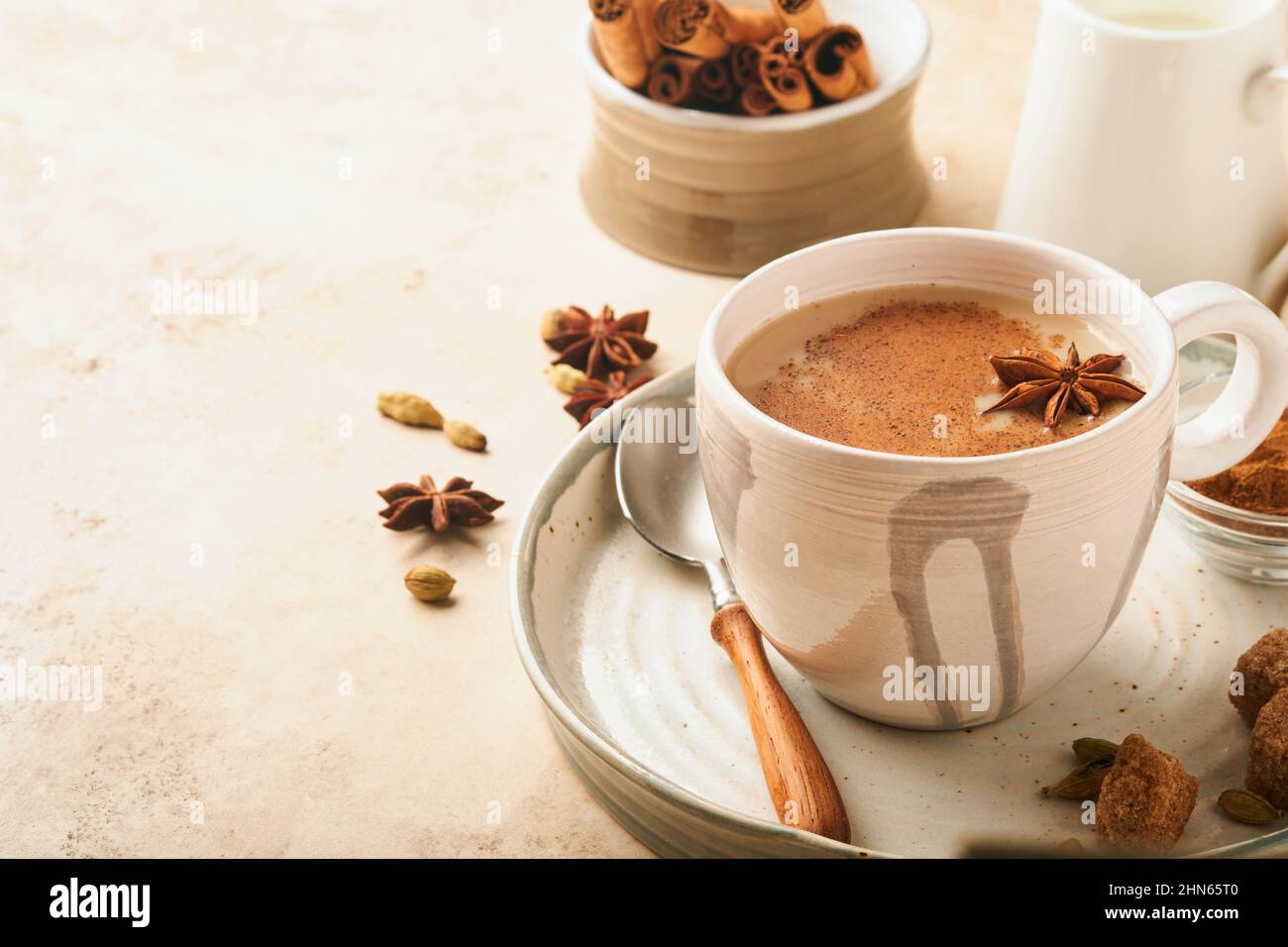 Masala tea. Masala chai spiced tea with milk and spices on light warm