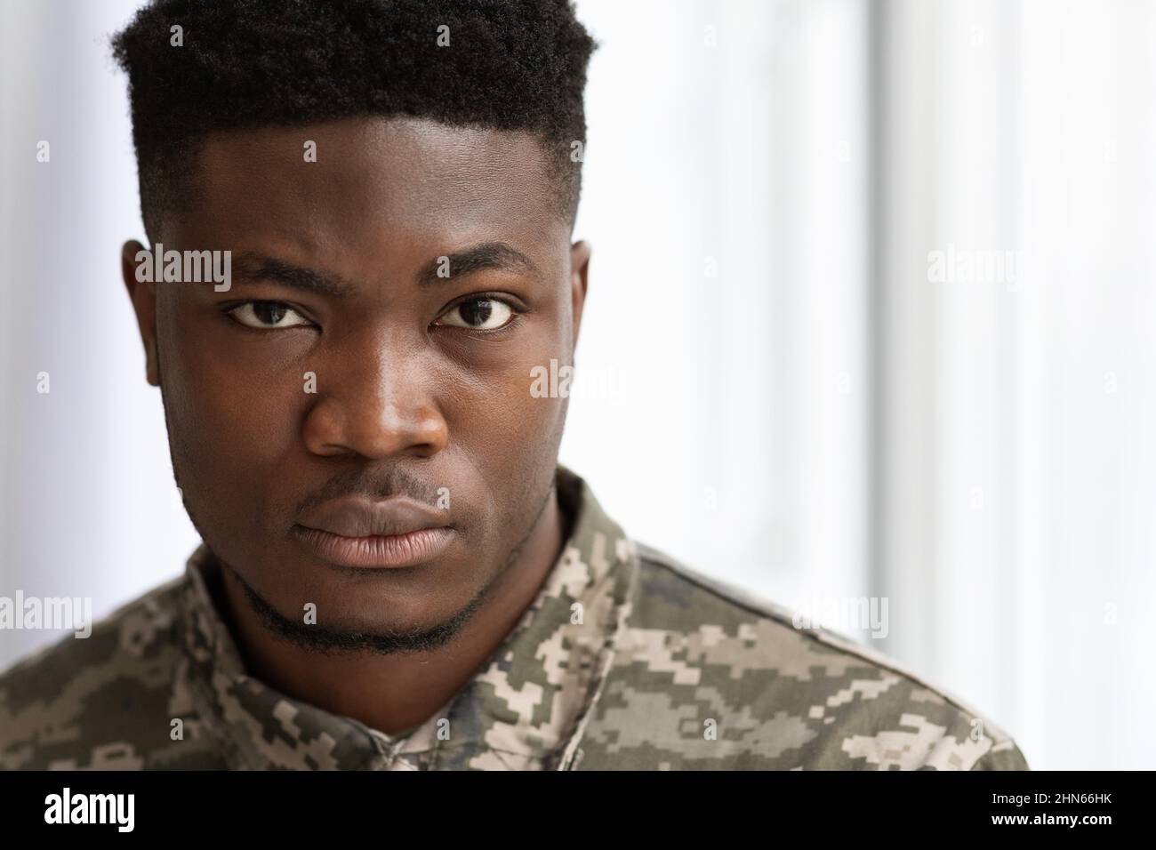 Closeup portrait of serious african american soldier looking at camera Stock Photo