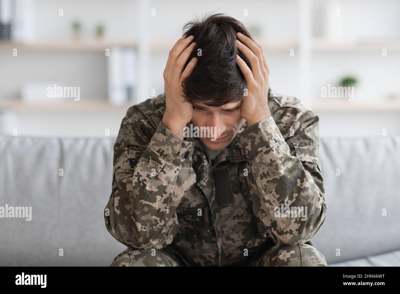 Depressed military man covering his head with palms Stock Photo Alamy