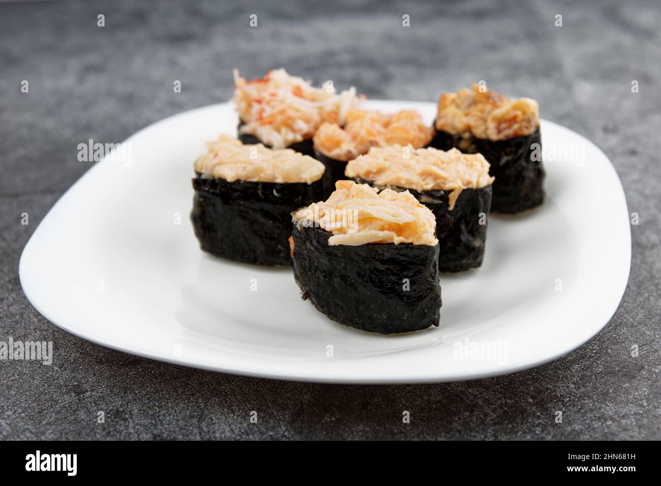 Set of gunkan sushi with spicy sauce on plate Stock Photo