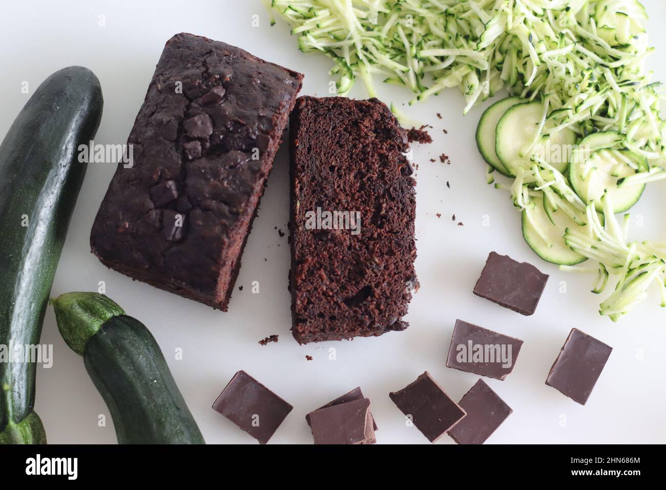 Zucchini chocolate cake slices. Moist double chocolate cake with grated zucchini, coco powder, chocolate and chocolate chips. Shot on white background Stock Photo