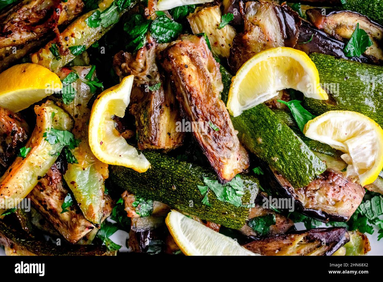 Closeup View of Roasted Aubergine and Courgette with Sumac and Herbs