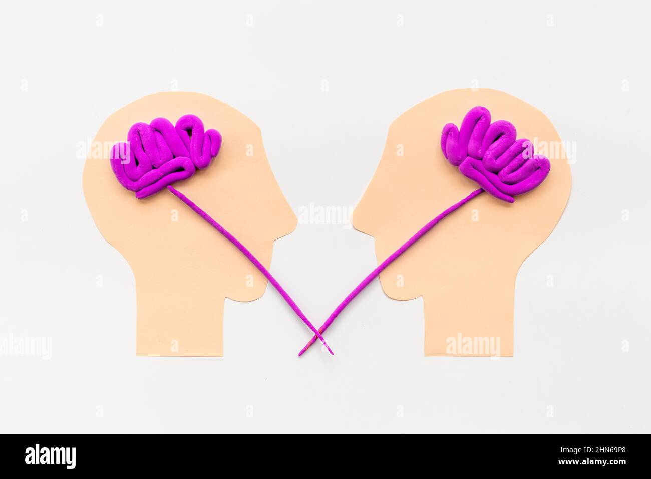 Human connection and communication. Brain on two paper human heads ...