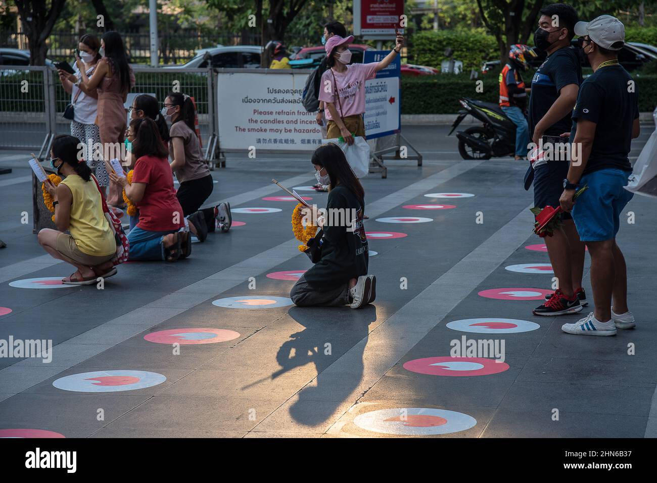 People are seen praying at the Trimuriti shrine in Bangkok. The 'Pray and swipe right' event organized by online dating app Tinder, with Social distancing Tinder logo markers on the praying ground, a photo booth where people can take profile pictures for their new accounts, and free offering sets, at the Trimuriti shrine on Valentine's day in Bangkok, Thailand. The Trimuriti one of the Hindu gods is known to be the god of love. People come to worship at the Trimurti shrine with offerings of red roses in the hope that they will meet their soulmate. (Photo by Peerapon Boonyakiat/SOPA Images/Si Stock Photo