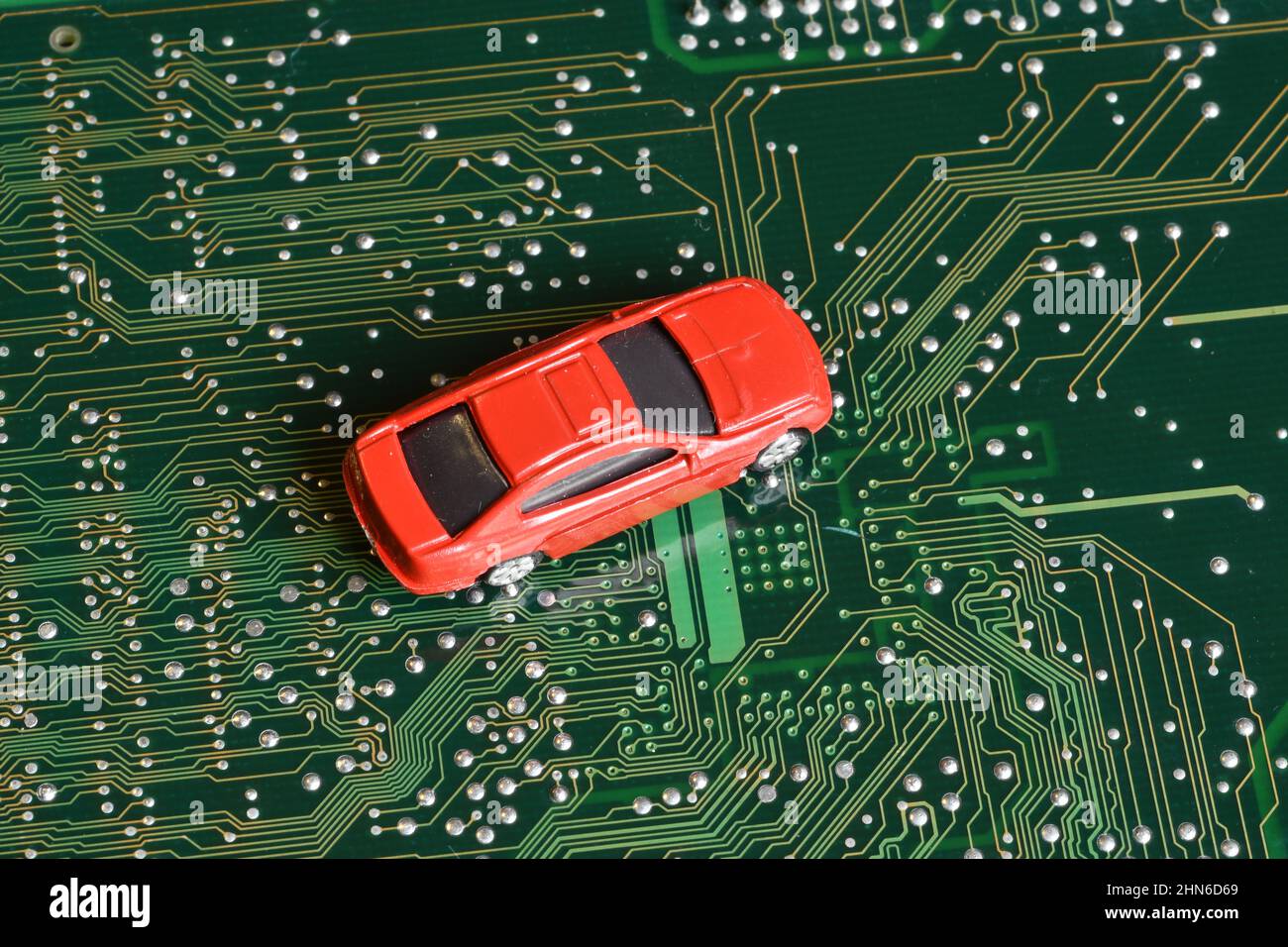 Toy cars on an electronic board with integrated circuits. The shortage