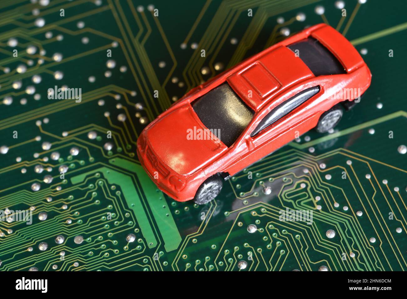 Toy cars on an electronic board with integrated circuits. The shortage