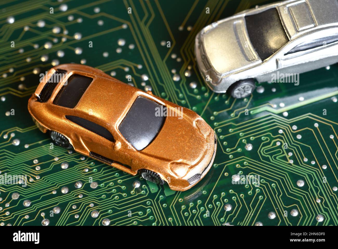 Toy cars on an electronic board with integrated circuits. The shortage
